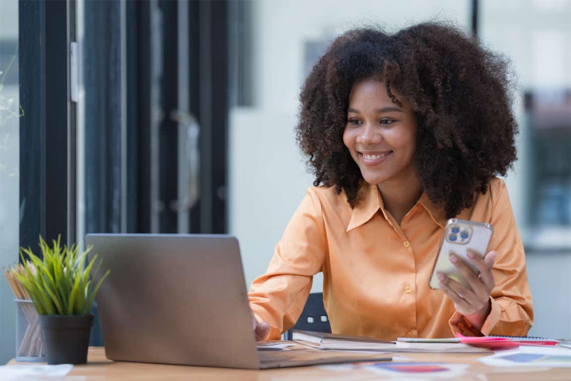 woman smiling checking finances